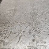 White cotton bedspread, crocheted sofa throw with star patterns