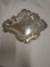 Old small silver-plated tray decorated with scrolls and leaves.