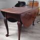 Élégante table ovale antique à abattants