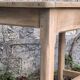 Art Deco farmhouse table made of raw wood.