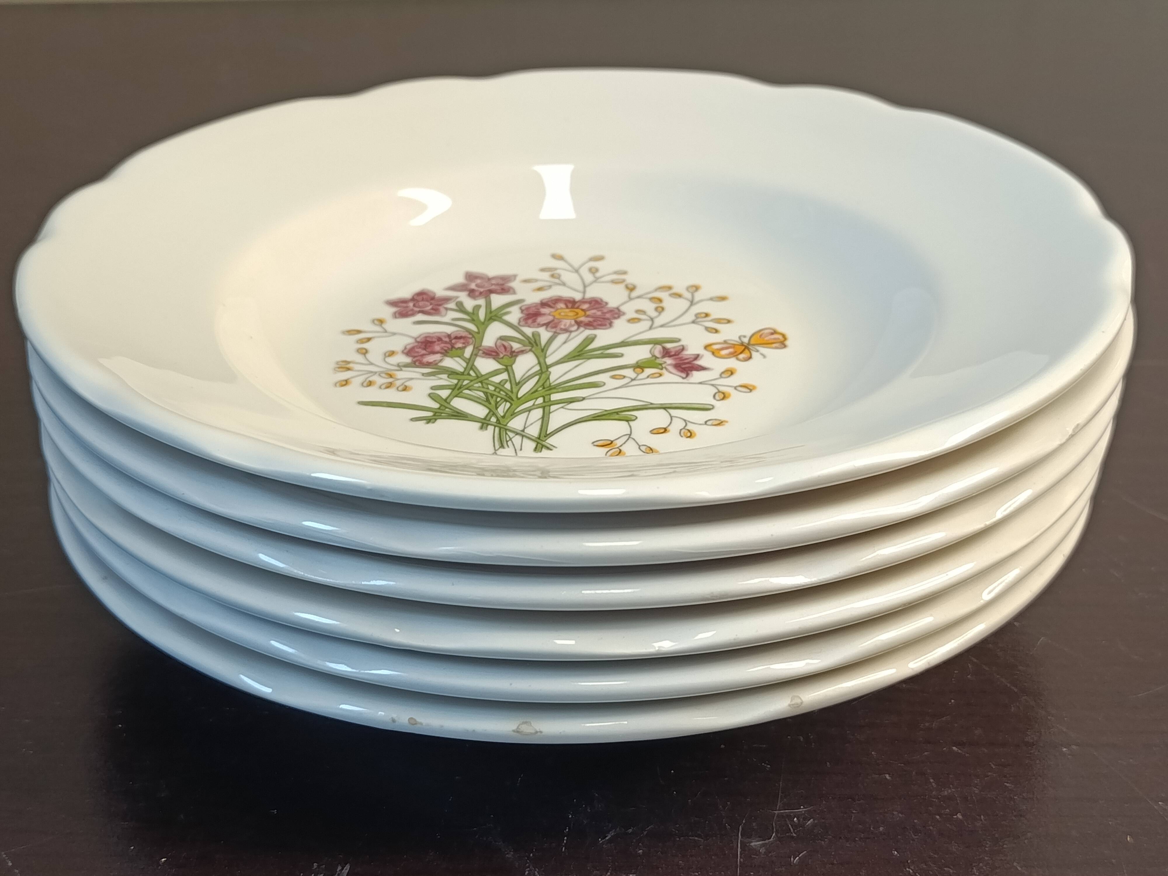 7 assiettes creuses CBM, décor champêtre floral et papillon, 1988