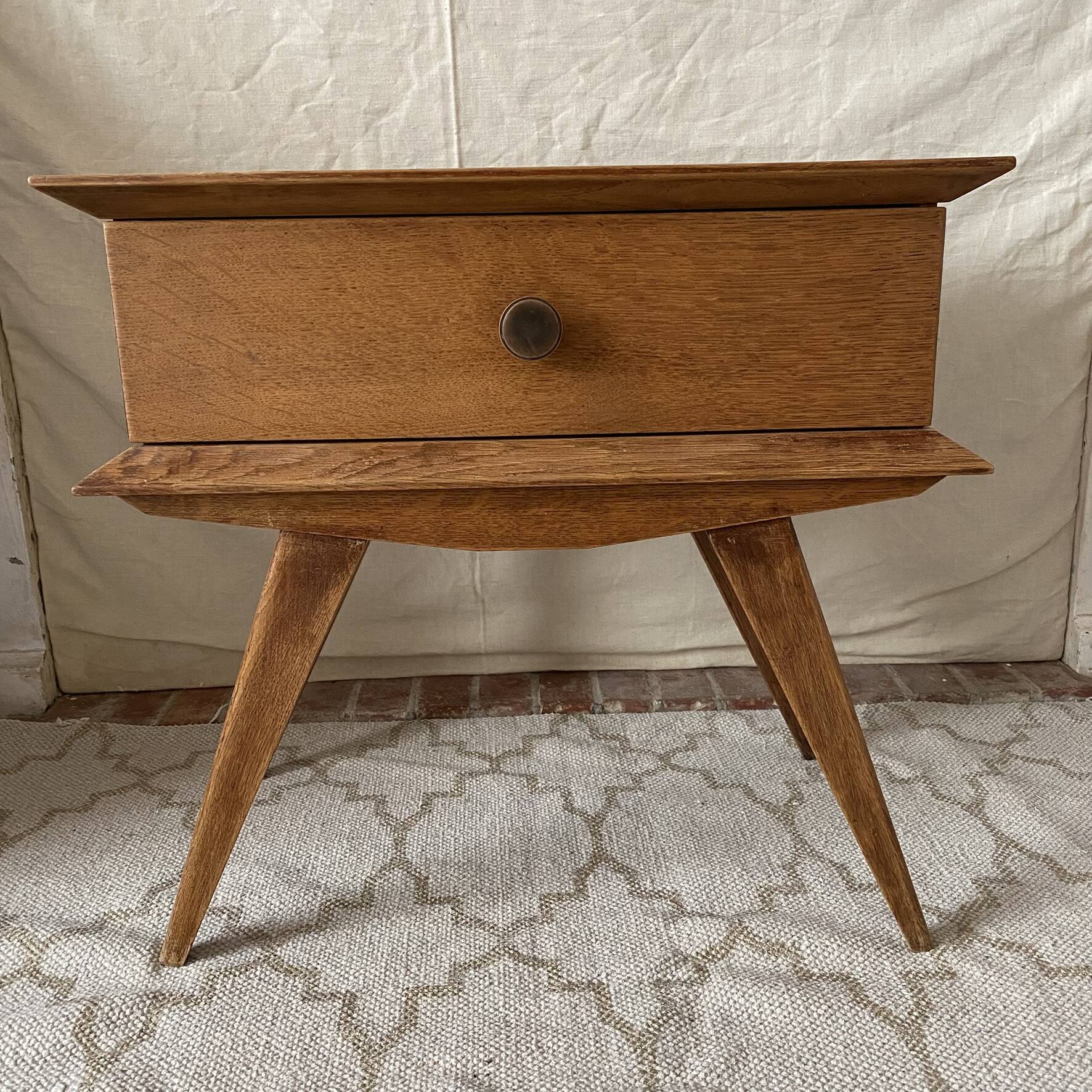 Scandinavian style bedside table with tapered legs from the 1960s.
