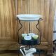 Foldable wrought iron support from the 19th century for a toilet set.