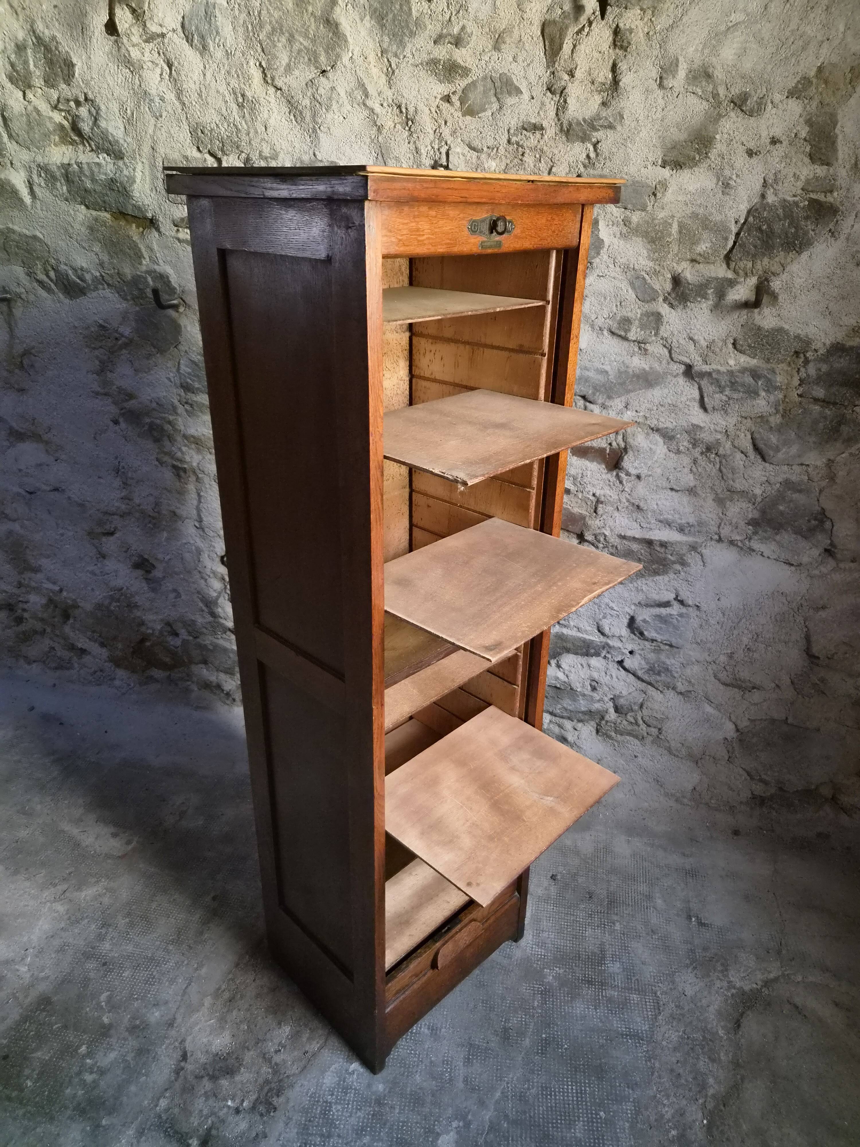 French antique wardrobe with curtain in oak, circa 1920–1930.