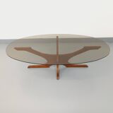 Vintage Hugues Poignant oval coffee table in teak and smoked glass from the 1970s