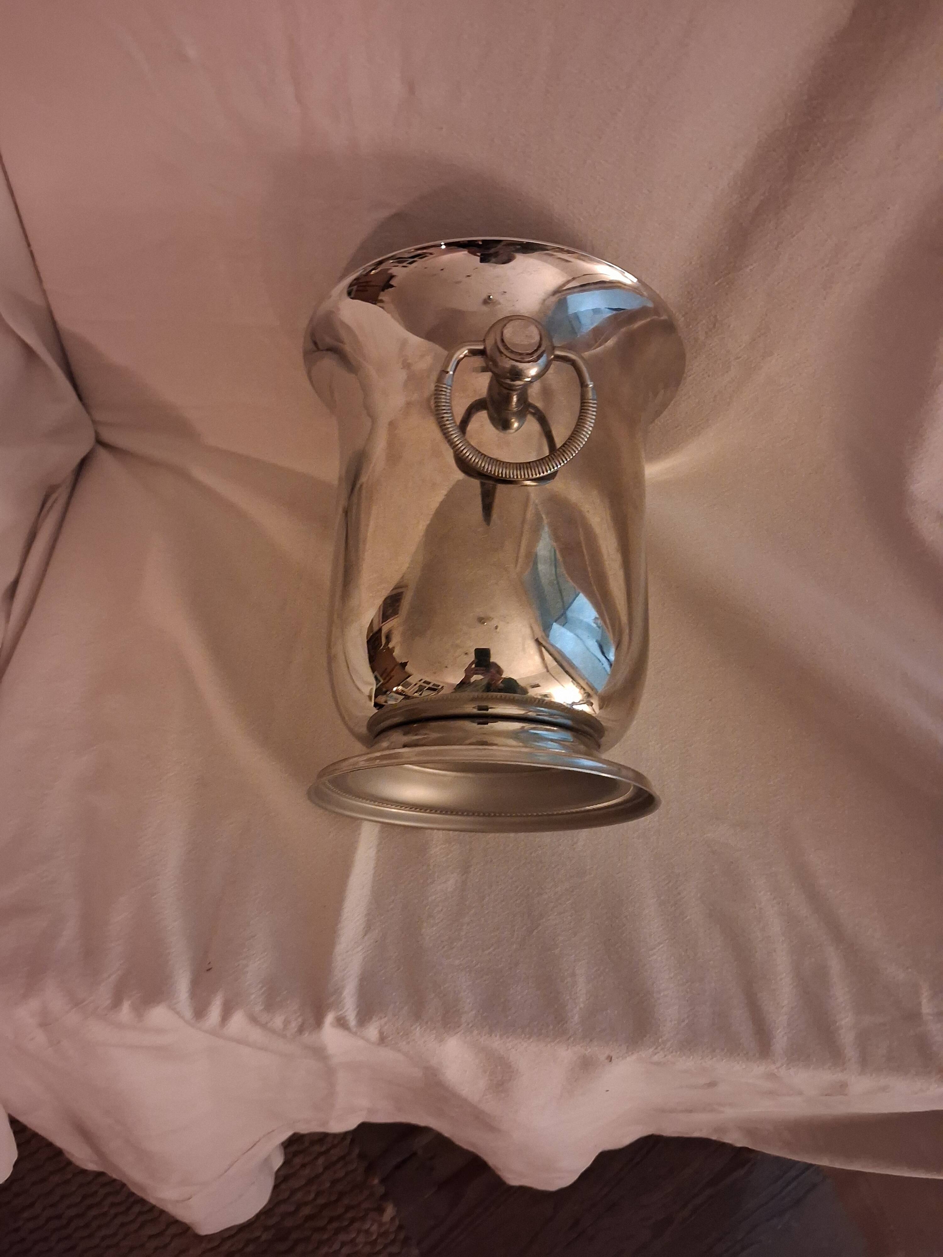 Stainless steel champagne bucket, silversmith Jean Couzon, model on a pedestal.