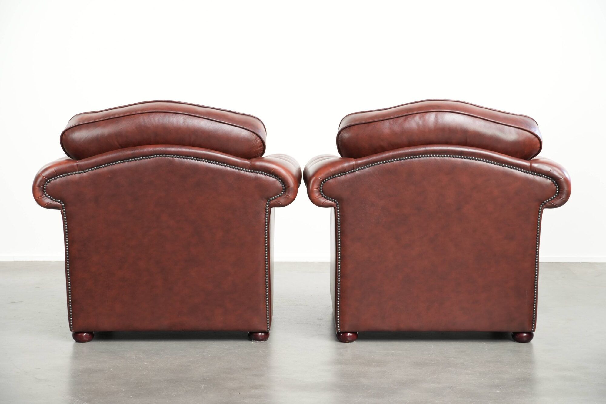 Vintage set of 2 cowhide leather Chesterfield armchairs in a brown colour