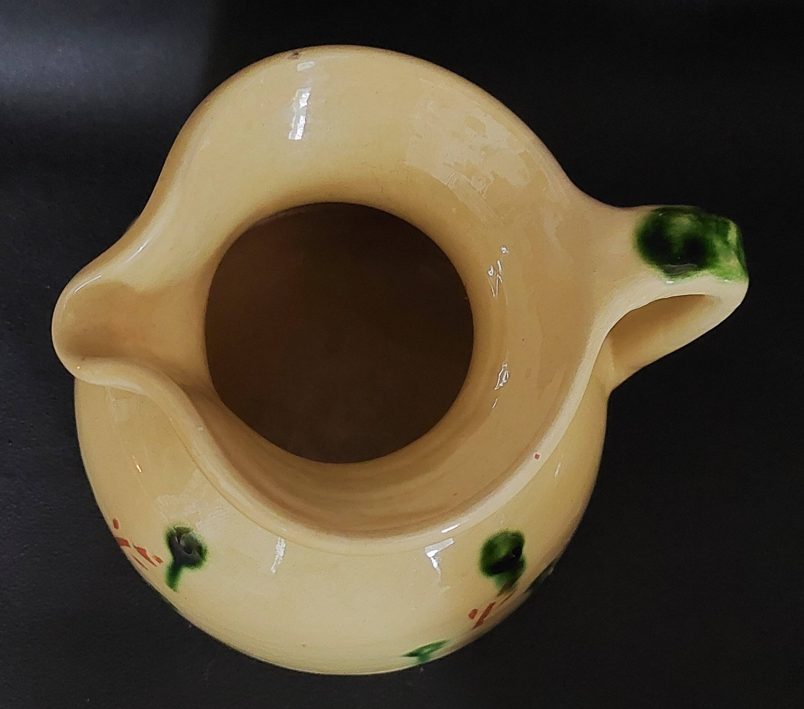 Vintage glazed terracotta ceramic jug from the 20th century.