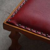 Danish sculpted oak stool from the mid-20th century with a red leather seat, 1950s.
