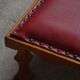 Danish sculpted oak stool from the mid-20th century with a red leather seat, 1950s.