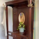Antique wooden coat rack with mirror and shelf.