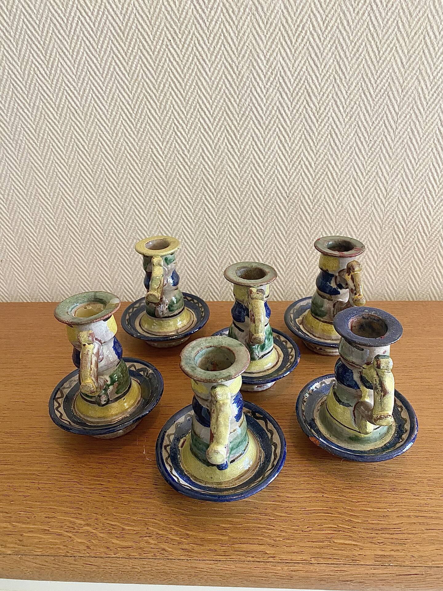 Many old glazed terracotta candlesticks.