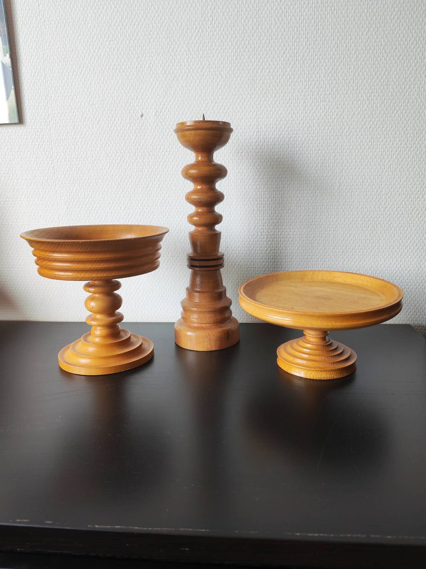 Vintage decor trio: candlestick and light wood bowls in Scandinavian style.