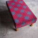 Large vintage bench upholstered in Scottish tartan fabric.