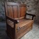Rustic French antique storage bench from the 18th century in walnut and pine.