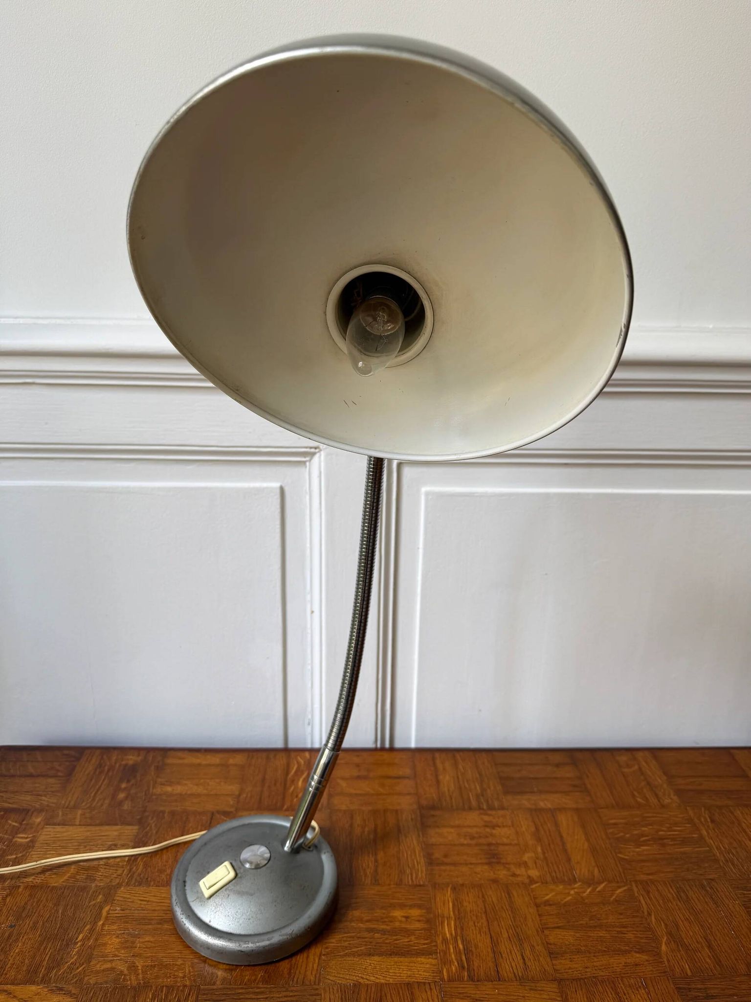 Industrial metal workshop lamp with a gooseneck.