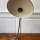 Industrial metal workshop lamp with a gooseneck.