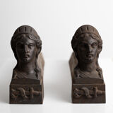 Pair of ancient cast iron chenets adorned with bust of Marianne