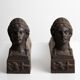 Pair of ancient cast iron chenets adorned with bust of Marianne