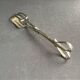 Cake tongs and spoon to sprinkle silver metal