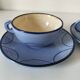 A pair of glazed ceramic cups and saucers from the 60s-70s.