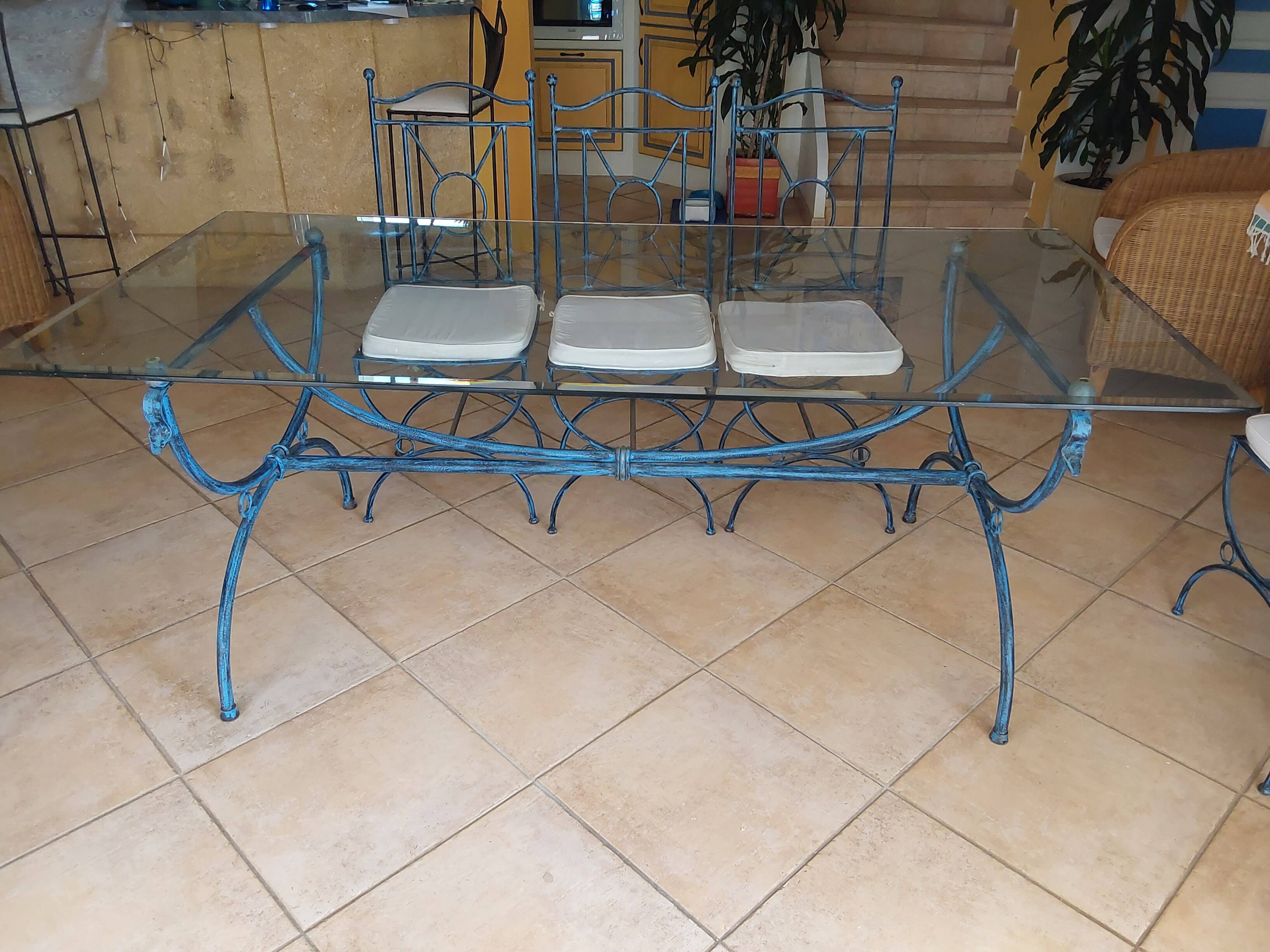 Wrought iron and bevelled glass table with 6 matching chairs.