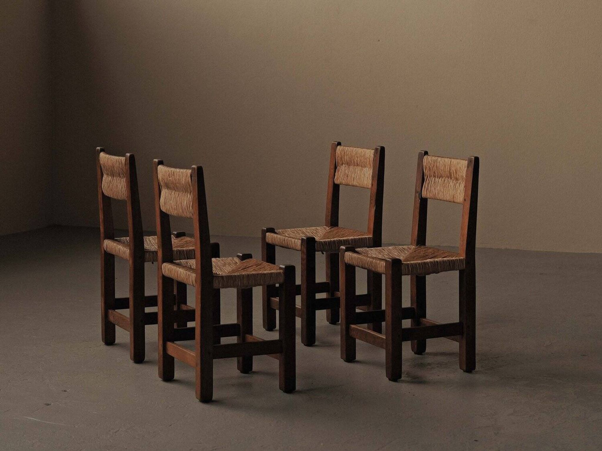 Set of four modernist chairs in oak and straw, France, circa 1960.