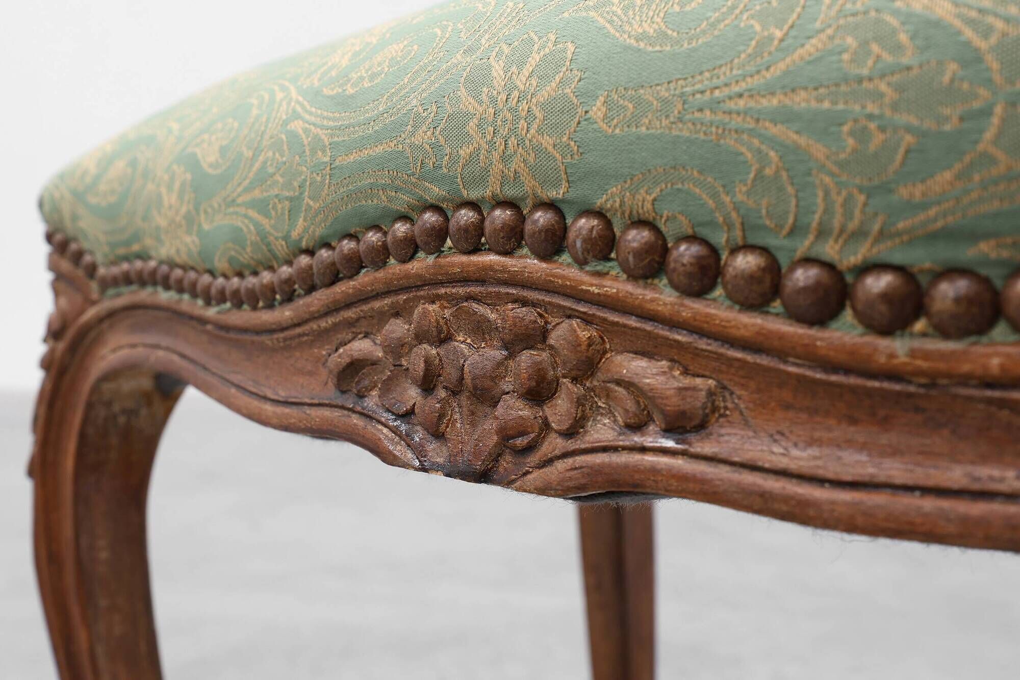 Louis XV stool with carved floral apron and original damask upholstery