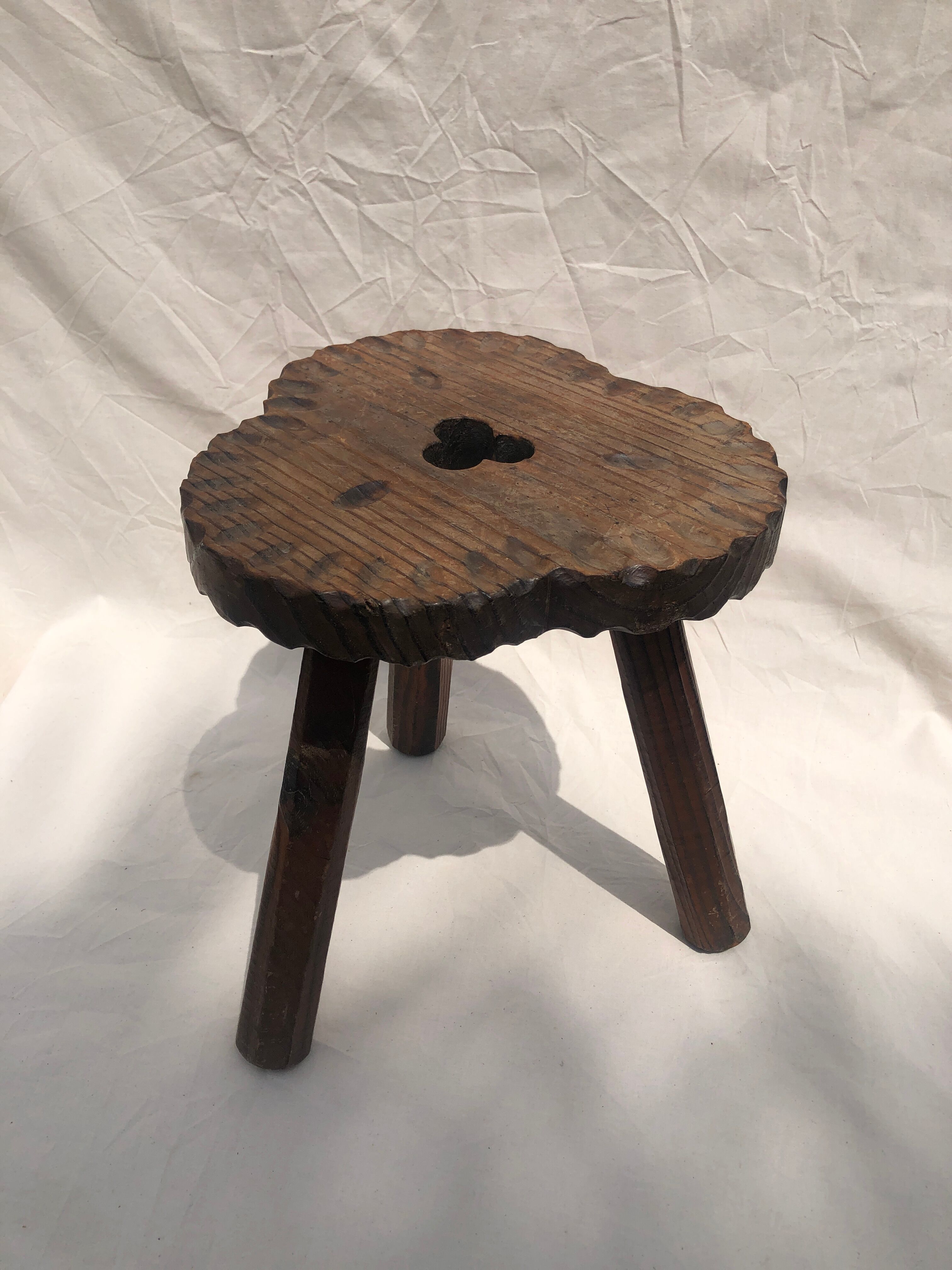 Chiseled wooden tripod stool