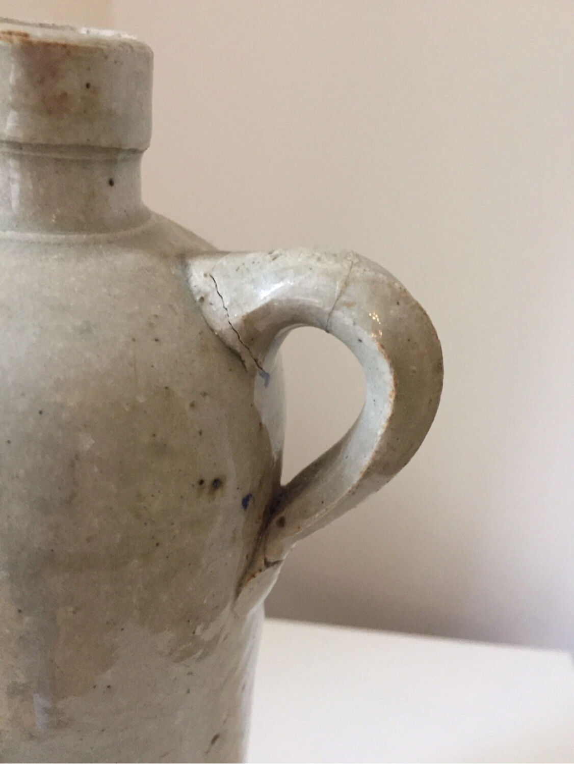 Antique grey stoneware bottle with vintage handle