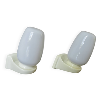 Pair of "streamline" opaline wall lights, France, 1970s-1980s.