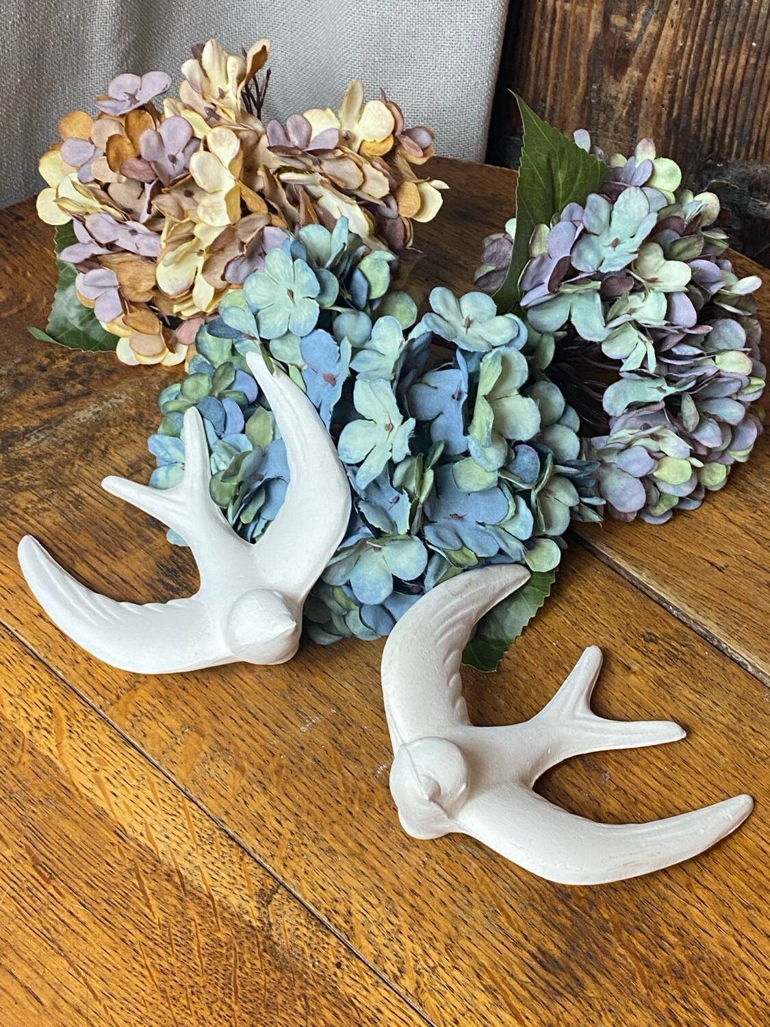 Pair of plaster swallows