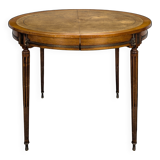 Louis XVI style dining table with a leather top.