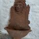 Old cast iron wall fountain with lion's head