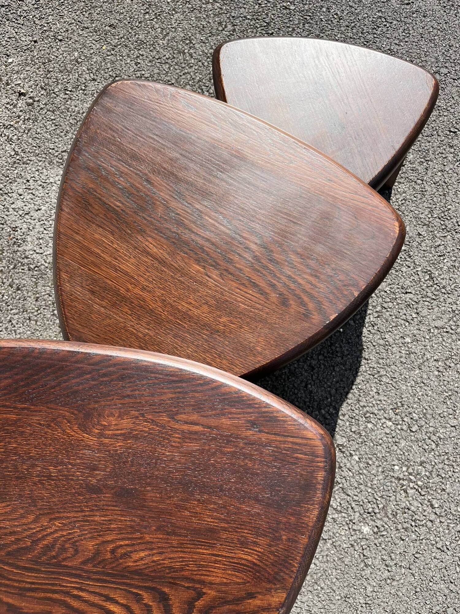 Nested tripod tables made of solid wood, in a modernist brutalist style.