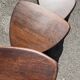 Nested tripod tables made of solid wood, in a modernist brutalist style.