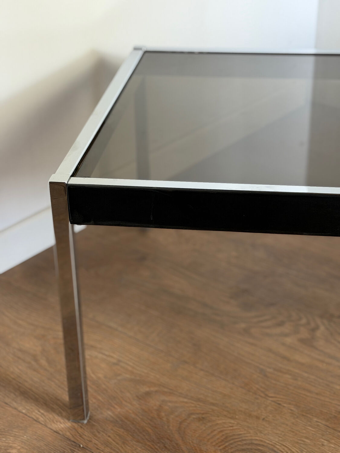 Large designer coffee table from the 70s in chrome, smoked glass, and faux leather.
