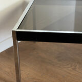 Large designer coffee table from the 70s in chrome, smoked glass, and faux leather.
