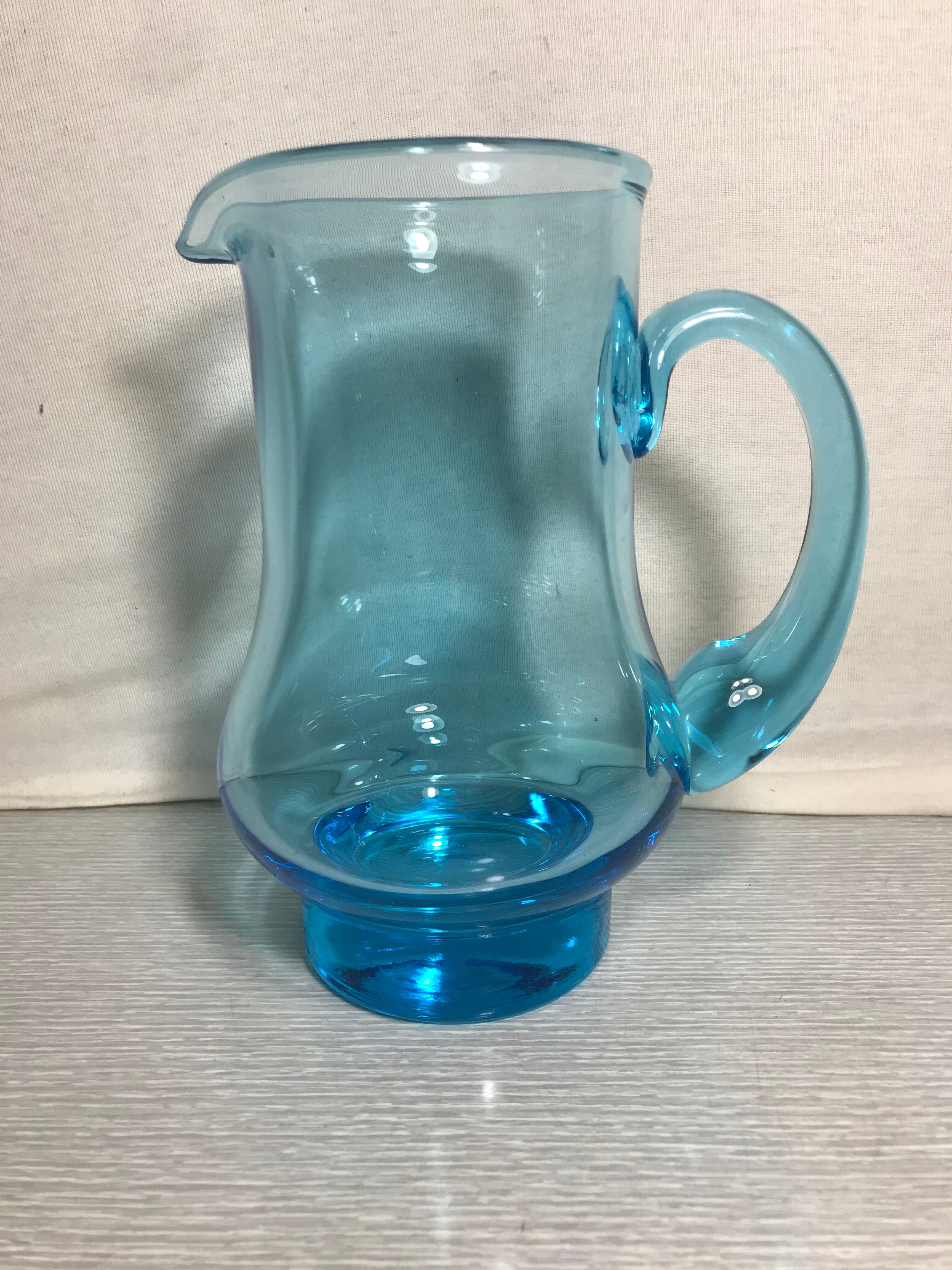 Old blue blown glass pitcher with vintage handle
