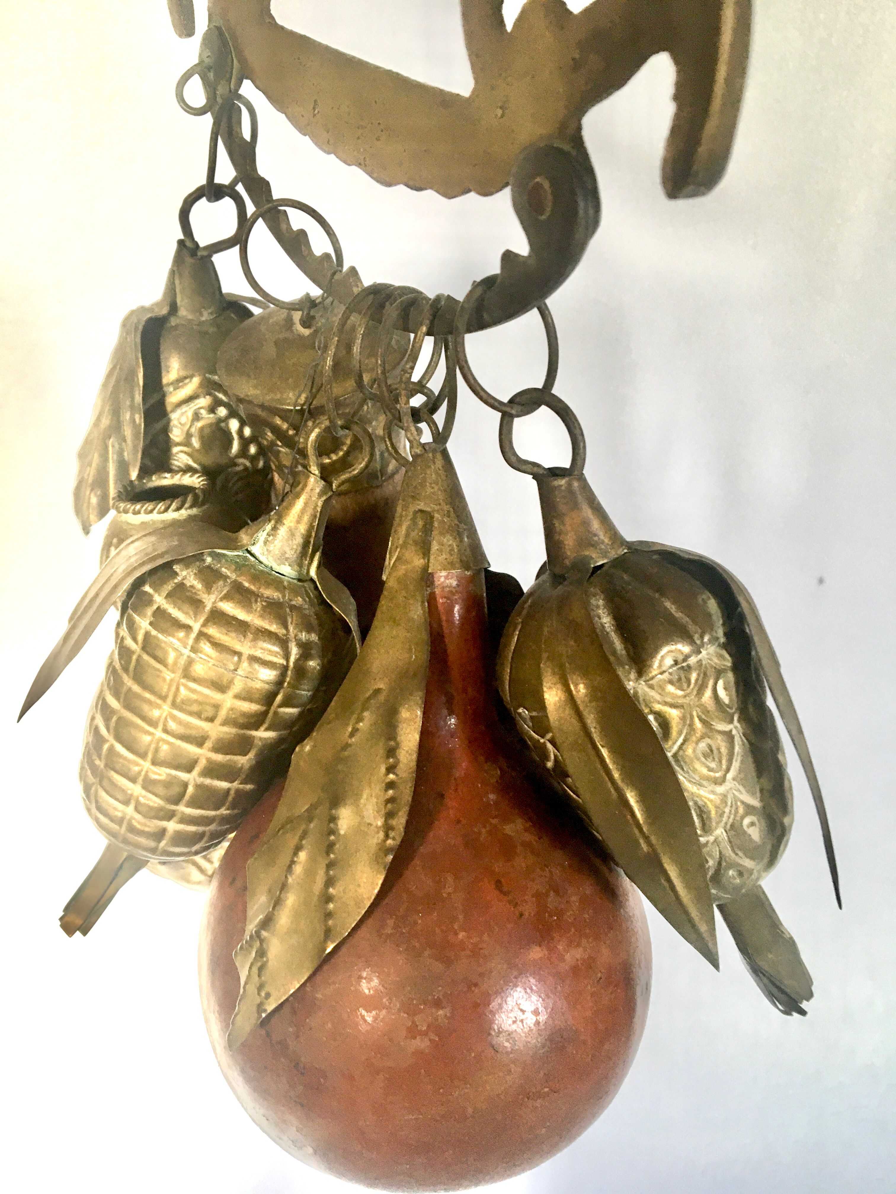 Wall decoration of brass and wood amulets