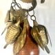 Wall decoration of brass and wood amulets