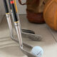 Old golf bag with 7 vintage clubs
