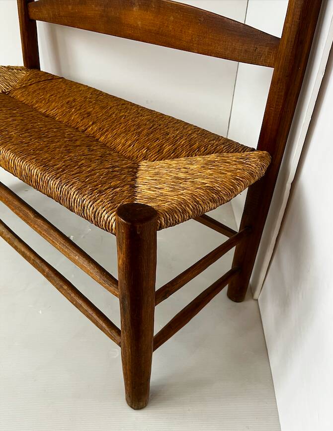 Old wooden and straw bench