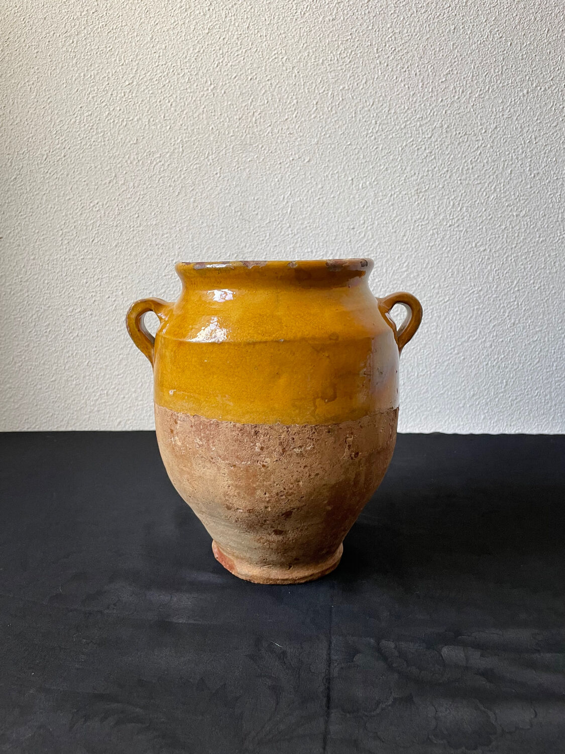Old candied pot in yellow glazed terracotta