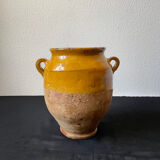 Old candied pot in yellow glazed terracotta