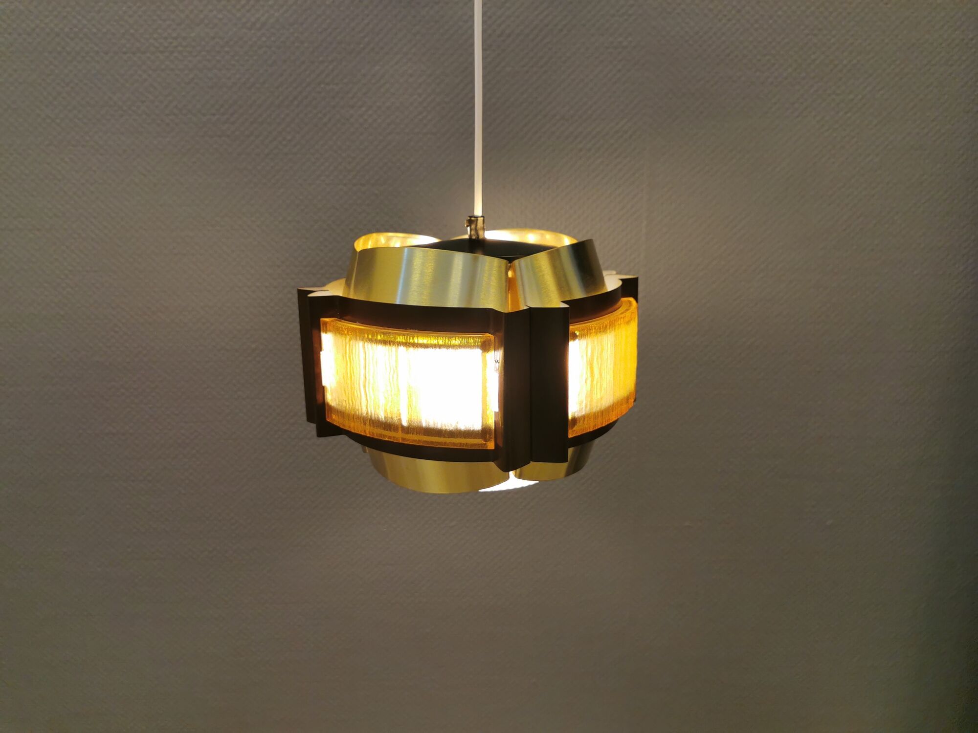Danish hanging lamp, made in brass colored and brown metal, with yellowish hard pressed plastic deta