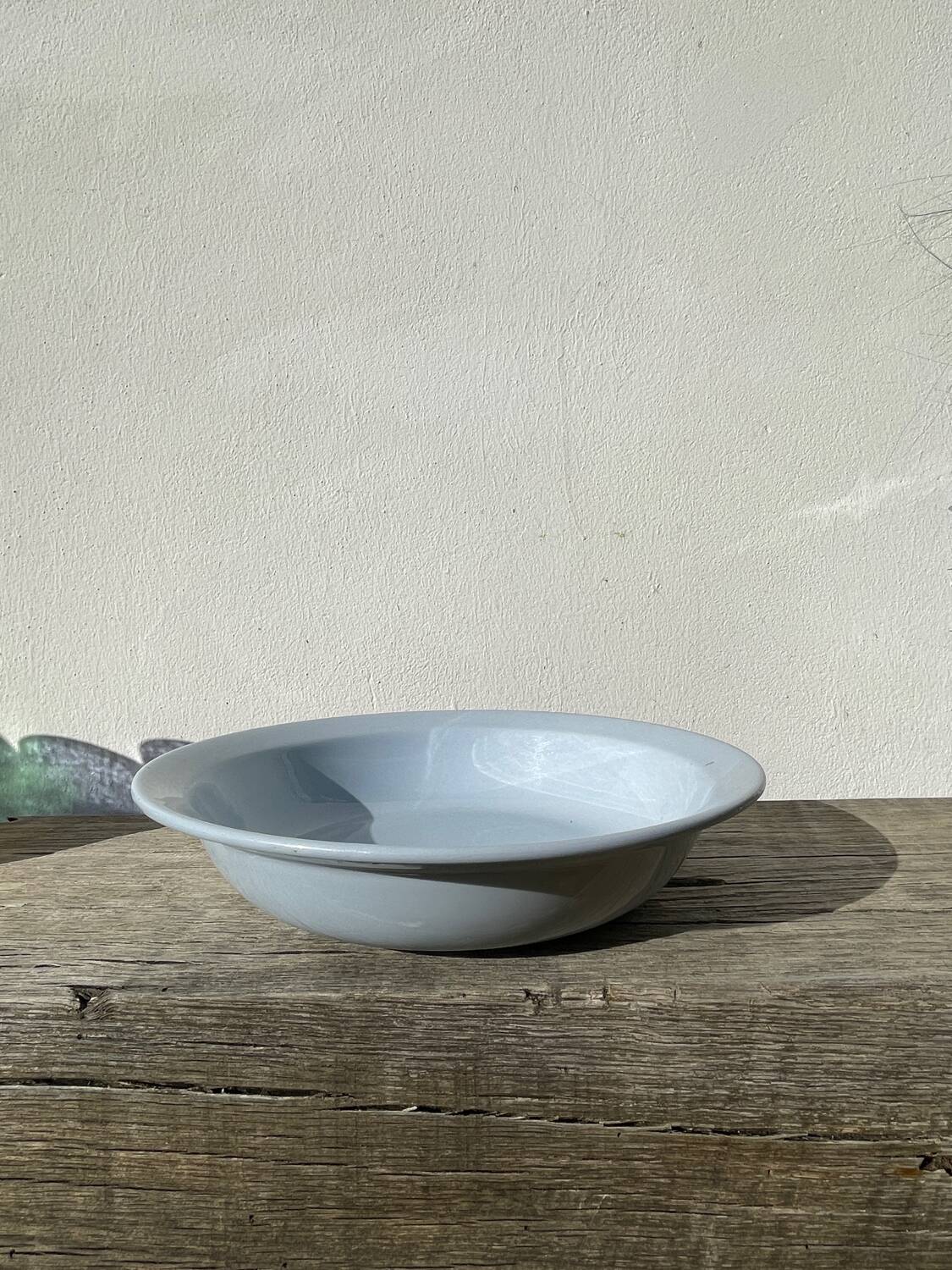Round, flat, sky-blue ceramic salad bowl from Moulin des Loups
