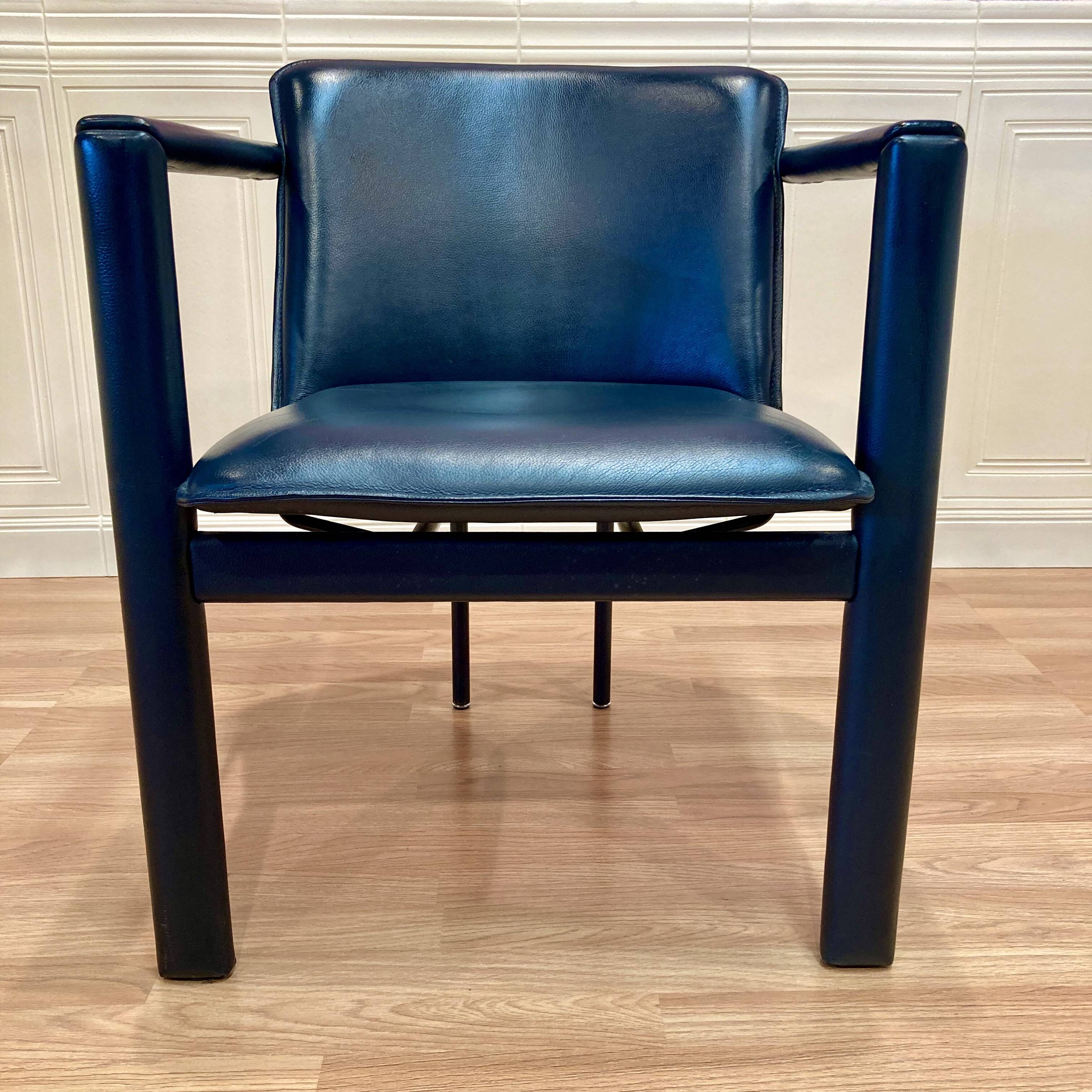 Design armchair in leather and metal.