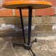 Vintage bistro table with black cast iron base and orange bakelite top, 1950s