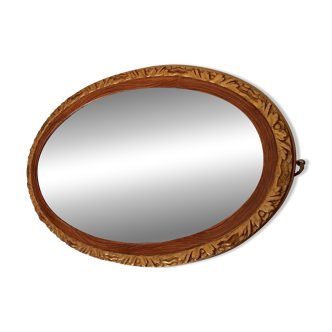 Antique oval mirror with beveled glass in wood and stucco, 19th century